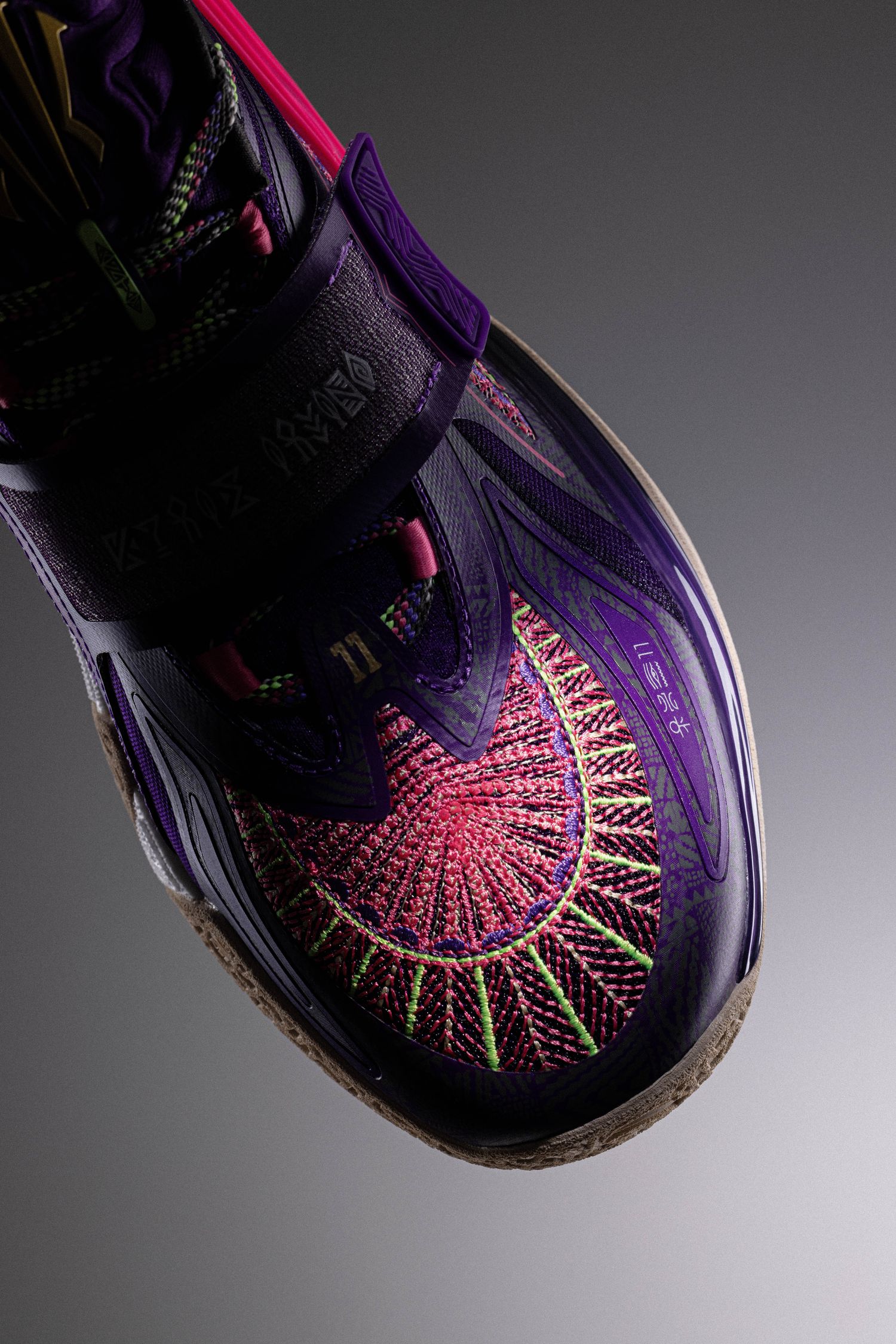The forefoot of Kyrie Irving's purple and red ANTA shoe.